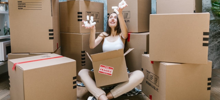 a girl sitting between boxes
